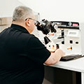 Person looking into microscope