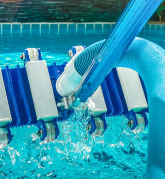 Pool vacuum above pool water